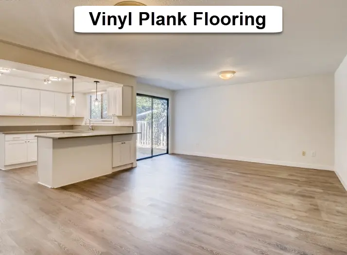 Vinyl plank flooring installation in Tigard showing new plank flooring installed throughout open living and kitchen area