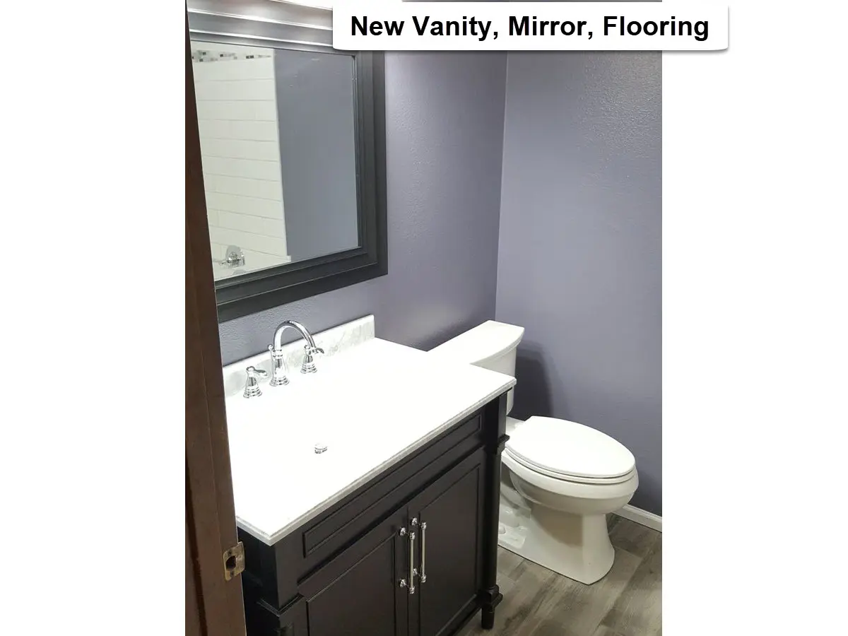 Bathroom vanity, mirror, and flooring installation in Tigard showing updated vanity cabinet, wall mirror, and new bathroom flooring