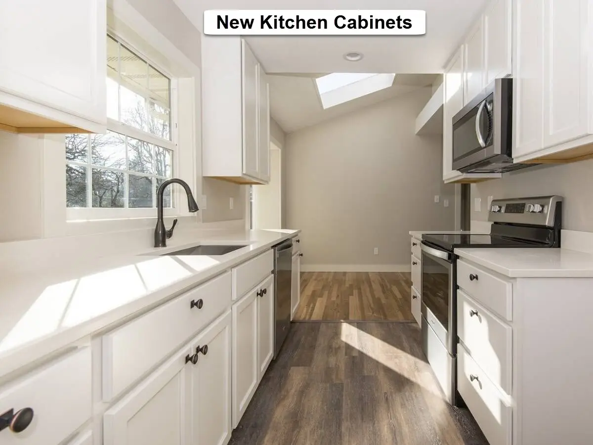 Kitchen cabinet installation in SW Portland showing new white cabinets installed in a galley kitchen layout